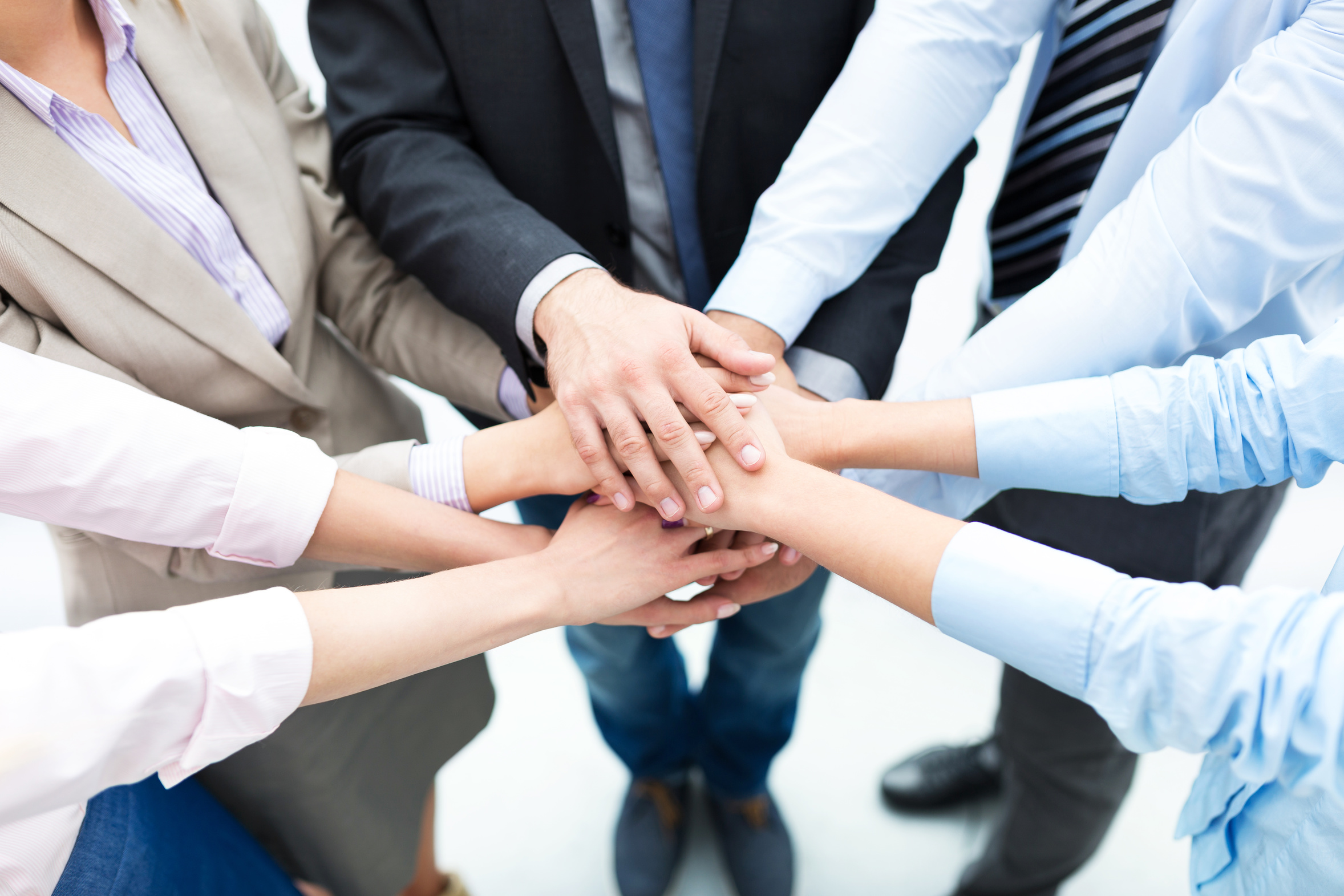 Business people joining hands in circle